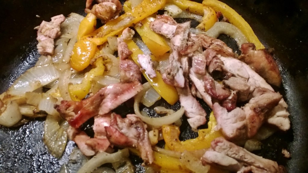 Chicken, onions and peppers ready to be cradled in a tortilla. A certain child of mine picked out all of the red peppers for her fajita before I could catch her!